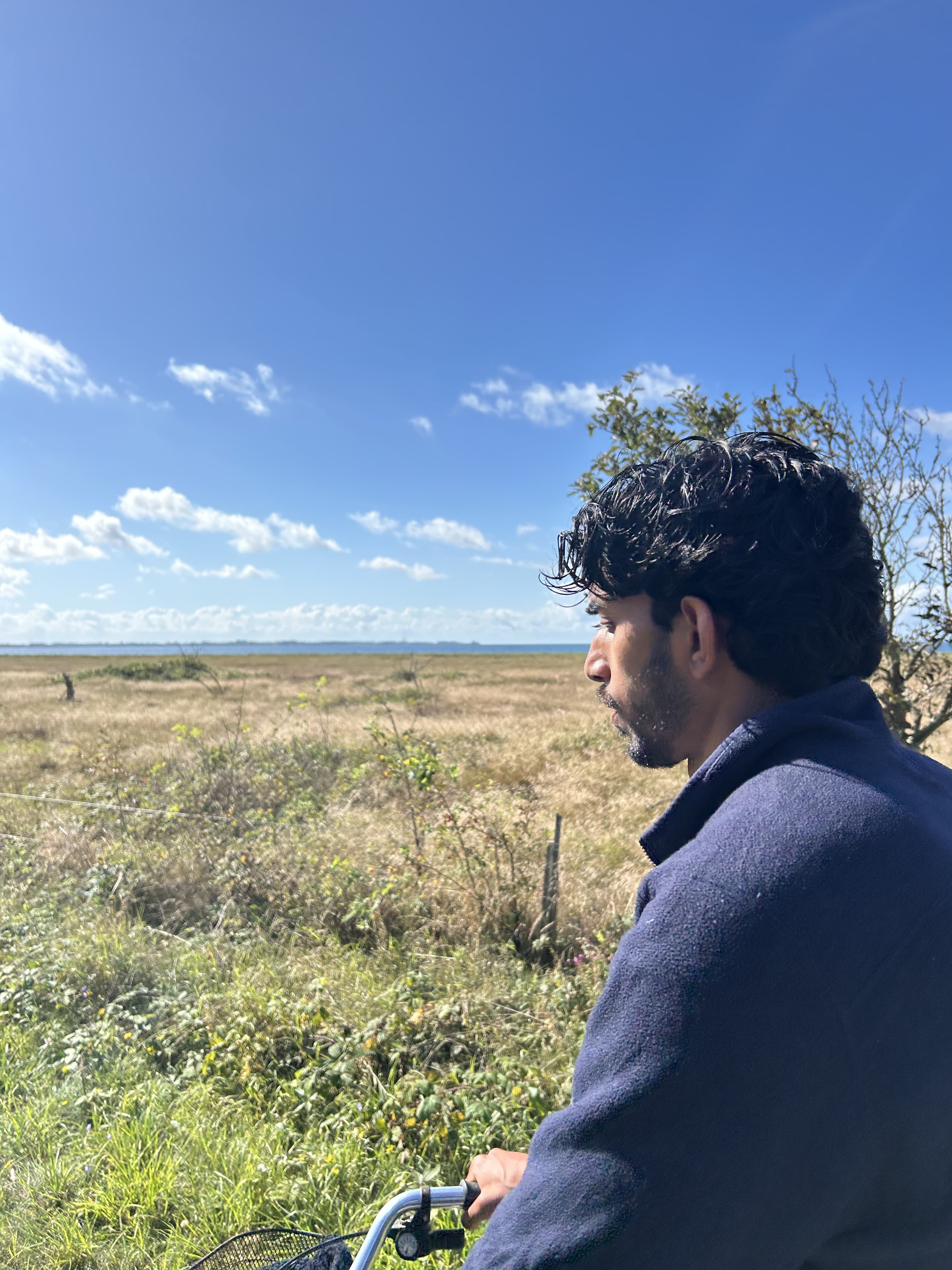 Side profile portrait of Robbin Natarajah cycling near Aarhus